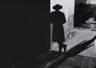 Silhouette of woman standing by railing