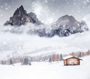 Scenic view of snow covered field against mountains