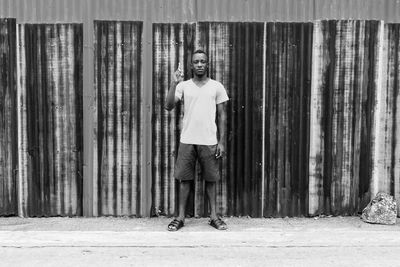 Portrait of man standing against wall