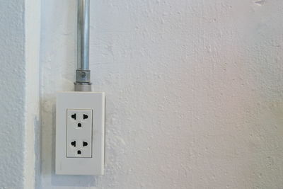 Close-up of electric outlet on wall