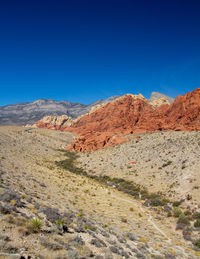 Scenic view of arid landscape against clear blue sky. red rock canyon, nevada 