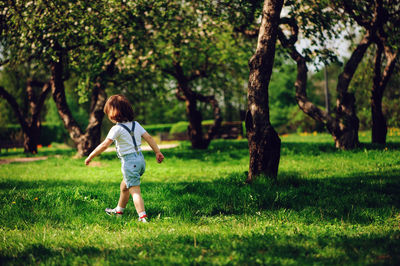 Full length of girl walking on field