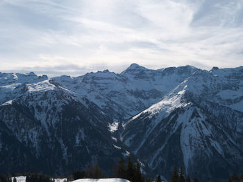 Scenic view of snowcapped mountains against sky