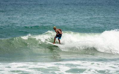 Full length of shirtless man in sea