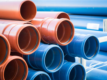 Close-up of stack of blue and brown plastic pipes 