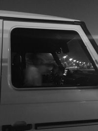 Rear view of man sitting in car window