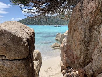 Scenic view of rocks on beach against sky
