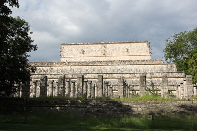 Low angle view of old building against cloudy sky