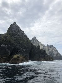 Rock formation in sea against sky