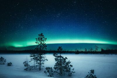 Scenic view of lake against sky at night