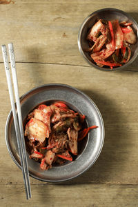 Top view a portion of homemade korean cabbage kimchi on rustic wooden table