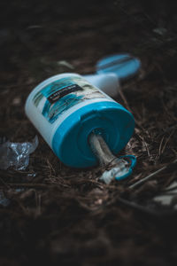 High angle view of plastic bottle on field
