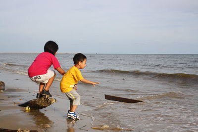 Two children playing at seashore