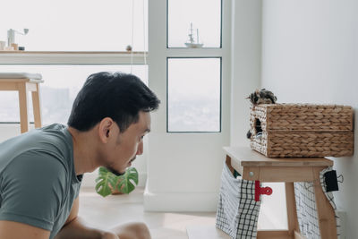 Side view of man working at home