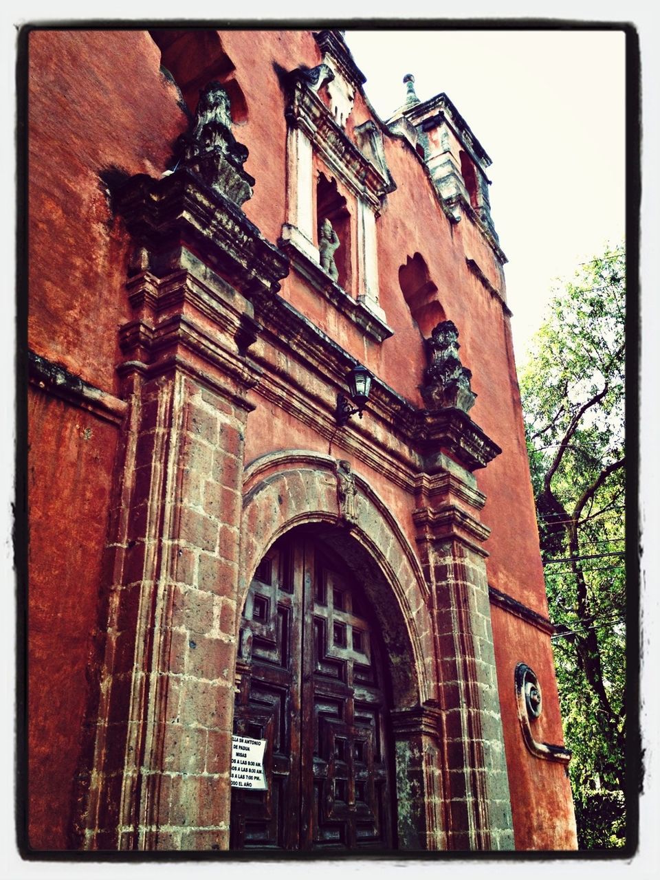 architecture, building exterior, transfer print, built structure, low angle view, auto post production filter, window, arch, old, facade, building, sky, history, outdoors, day, no people, text, city, brick wall, door