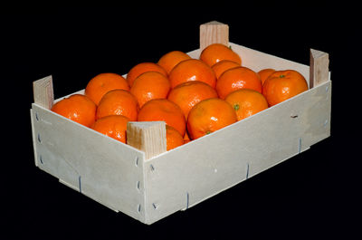 Close-up of orange eggs against black background