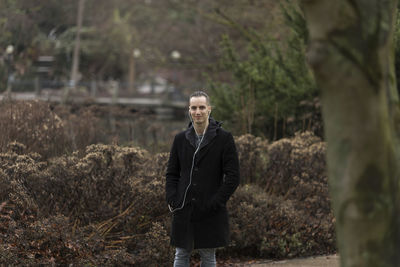 Portrait of smiling man standing on land