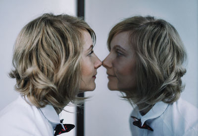 Beautiful woman reflecting in mirror