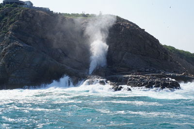 Scenic view of sea against mountain at huatulco