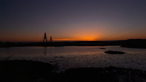 Scenic view of beach against sky during sunset