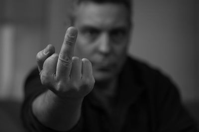 Portrait of rude man showing middle finger