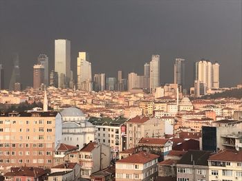 Buildings in city against clear sky