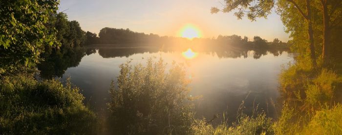 Scenic view of lake against sky during sunset