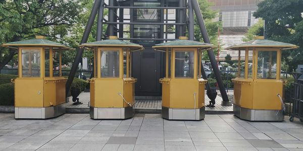 Empty seats in row against buildings