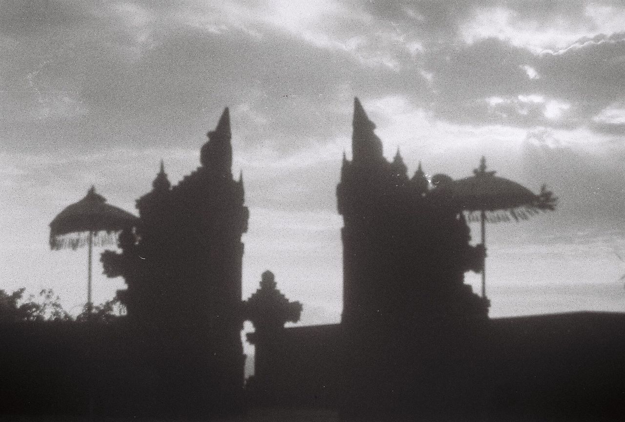 SILHOUETTE OF PEOPLE OUTSIDE TEMPLE BUILDING