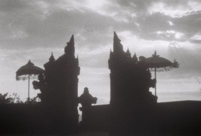 Silhouette of building against cloudy sky