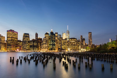 View of skyscrapers in city against blue sky