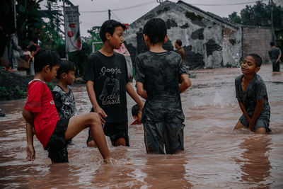 Rear view of woman standing in sea