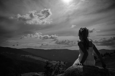 Man standing on mountain against sky