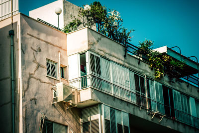 Low angle view of buildings against clear blue sky