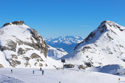 Scenic view of snowcapped mountains against clear sky