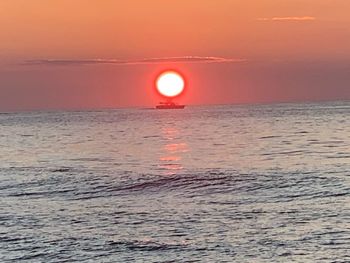 Scenic view of sea against orange sky