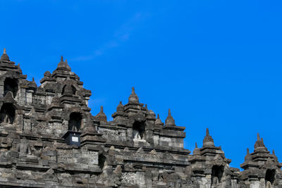 Low angle view of historical building against clear blue sky