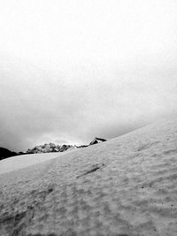 Scenic view of snow covered land against sky