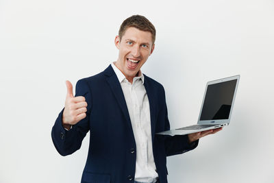 Portrait of businessman standing against white background