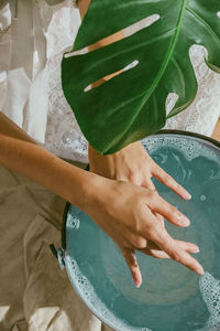 Midsection of woman cleaning hands in water