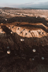 High angle view of hot air balloons over rock formations