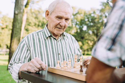 Midsection of man playing with table