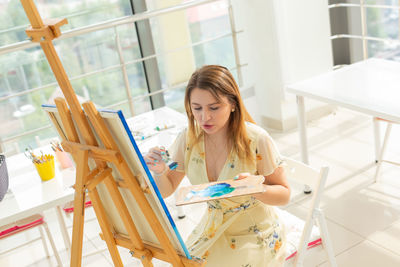 Woman painting at home