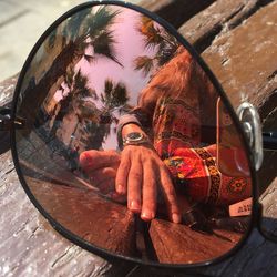 Portrait of woman photographing in mirror