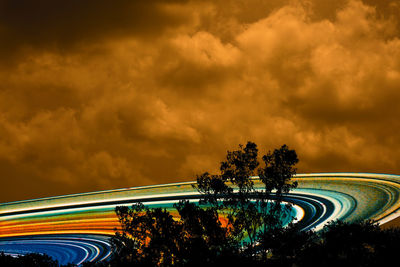 Scenic view of illuminated saturn ring against sky at sunset