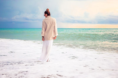 Rear view of man standing on beach