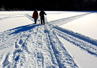 Men walking on snow covered landscape