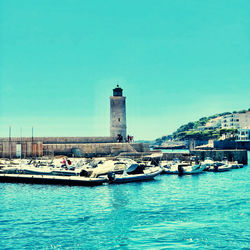 View of lighthouse in sea against clear sky