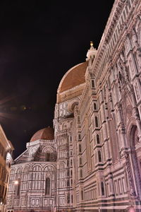 Low angle view of ornate building against sky at night