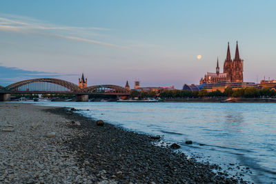 Bridge over river with buildings in background